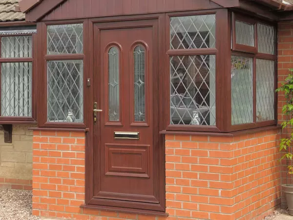 A Brick Porch With A Brown Door