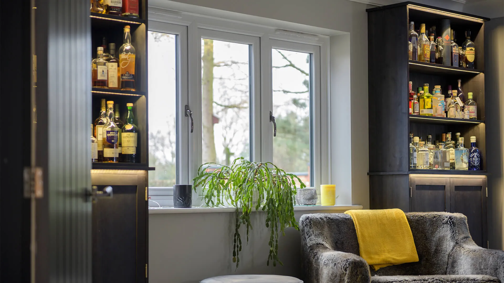 A white UPVC window and drinks cabinet